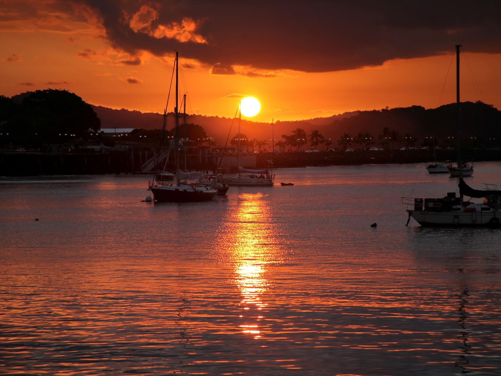 silhouette of boat on sea during sunset