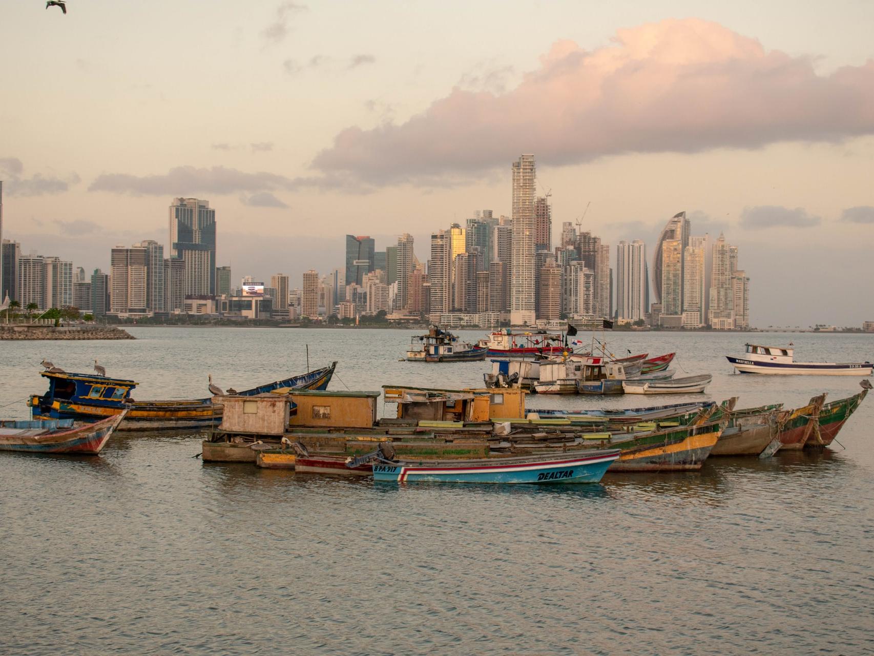 boats on the sea near buildings during daytime